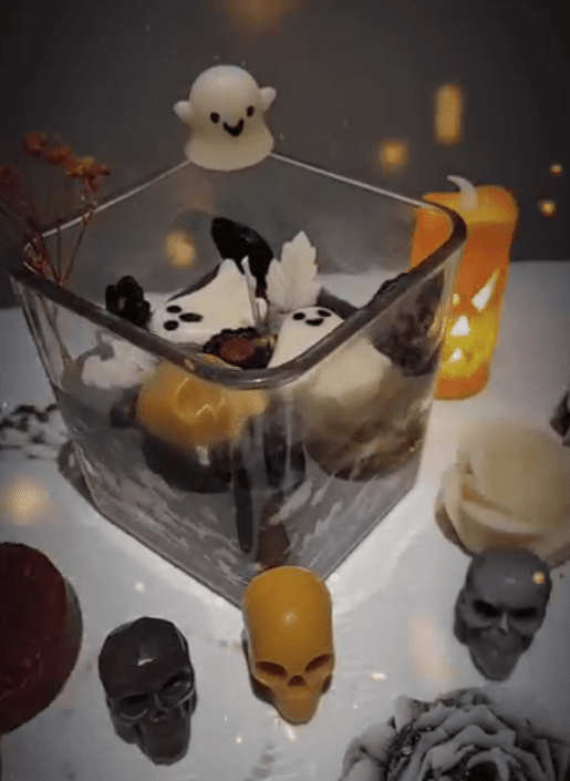Halloween candles: ghosts, pumpkins and skulls in a glass holder